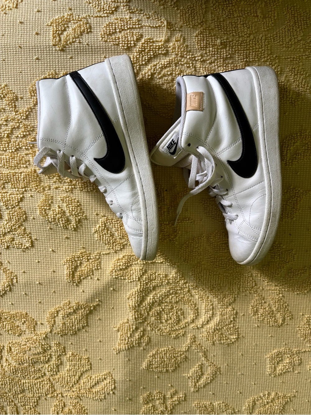 Nike White Mid-Top Sneakers with Black Swoosh